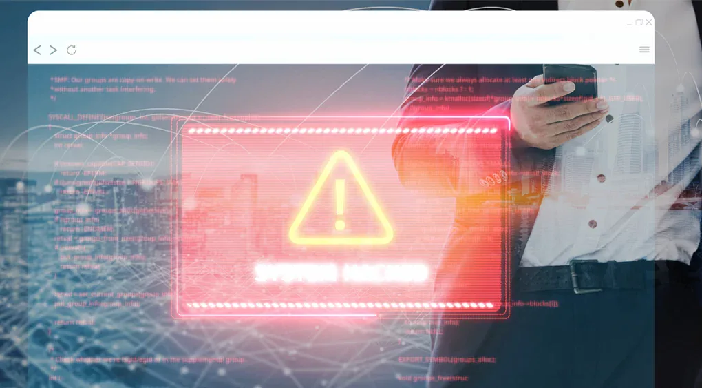 Ein neonfarbenes Warnzeichen mit einem Ausrufezeichen und dem Schriftzug SYSTEM HACKED erscheint vor einem unscharfen Hintergrund mit einer Person, die ein Telefon, einen Code und eine Stadtlandschaft in der Hand hält - und unterstreicht damit die Dringlichkeit von Prävention und schneller Wiederherstellung.